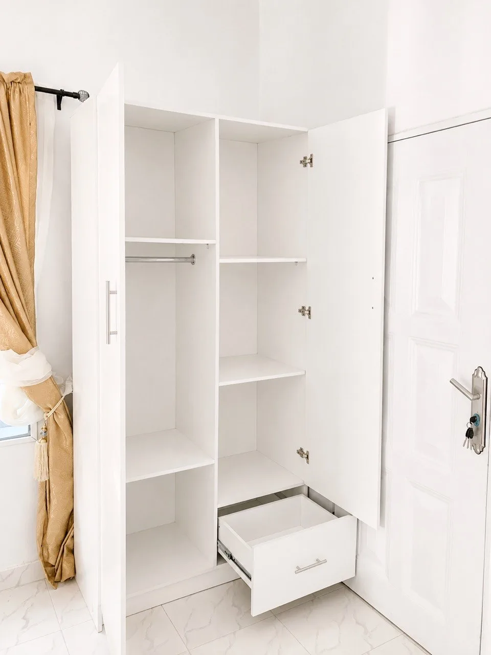 Custom-made board wardrobe with compartments, drawer and clothes hanging pole