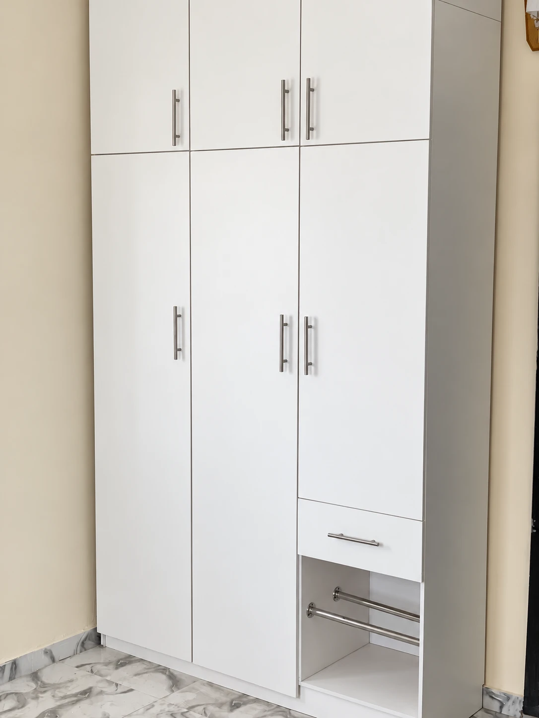 Three-door wardrobe with top cabinets, a drawer and an open shoe rack section